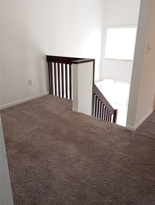 interior space with carpet floors and baseboards