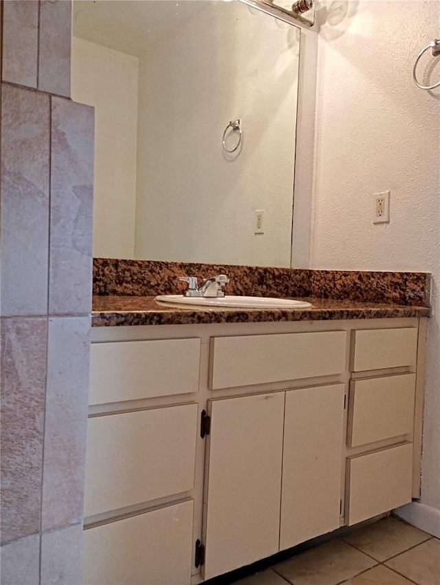 bathroom with tile patterned flooring and vanity