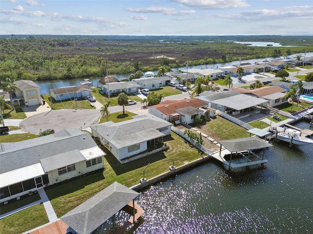 birds eye view of property with a water view, a wooded view, and a residential view