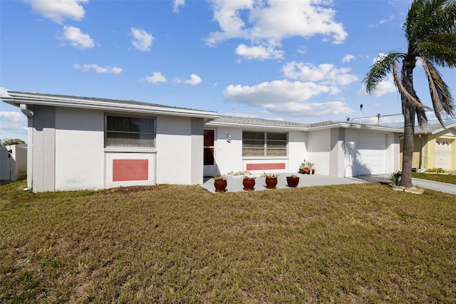 ranch-style home with concrete driveway, an attached garage, a front lawn, and stucco siding