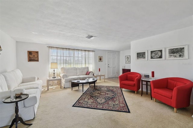 carpeted living area featuring visible vents