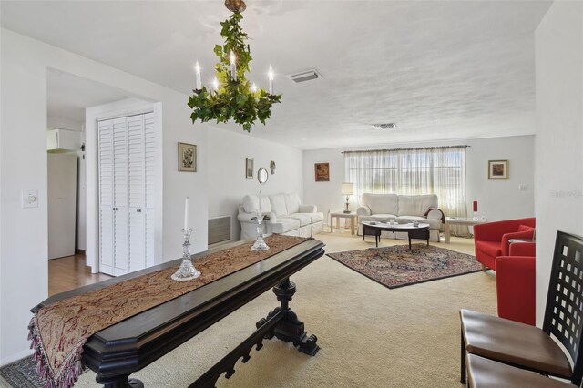 living area featuring a textured ceiling, carpet, and visible vents