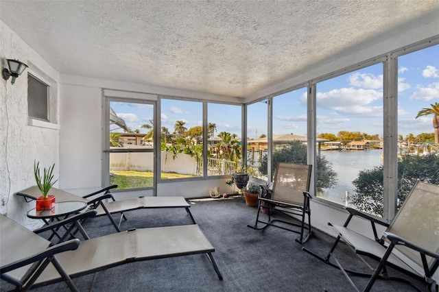 sunroom / solarium featuring a water view