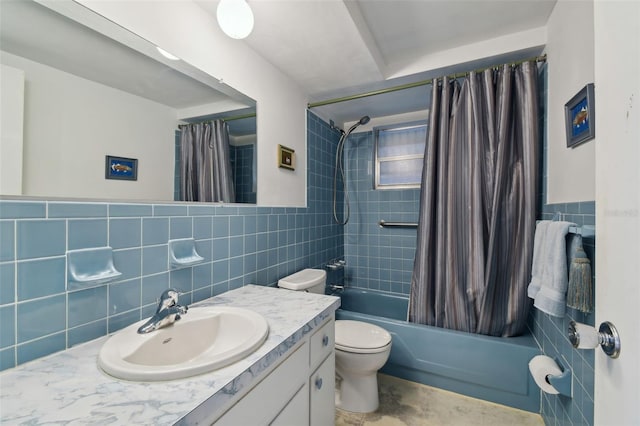 bathroom with toilet, a wainscoted wall, shower / tub combo, vanity, and tile walls