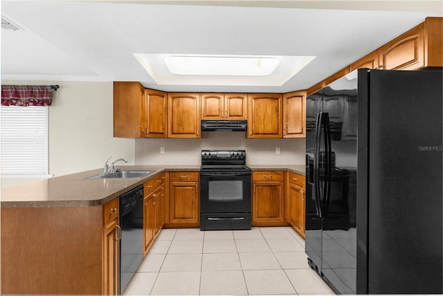 kitchen with range hood, brown cabinetry, a sink, black appliances, and a raised ceiling