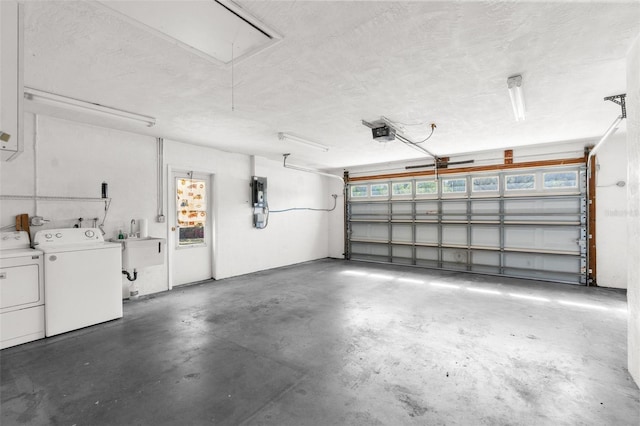 garage featuring a garage door opener and separate washer and dryer