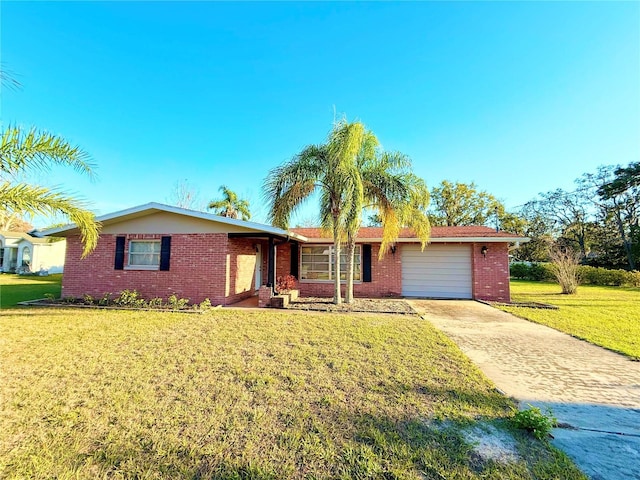 ranch-style house featuring a garage, concrete driveway, brick siding, and a front lawn