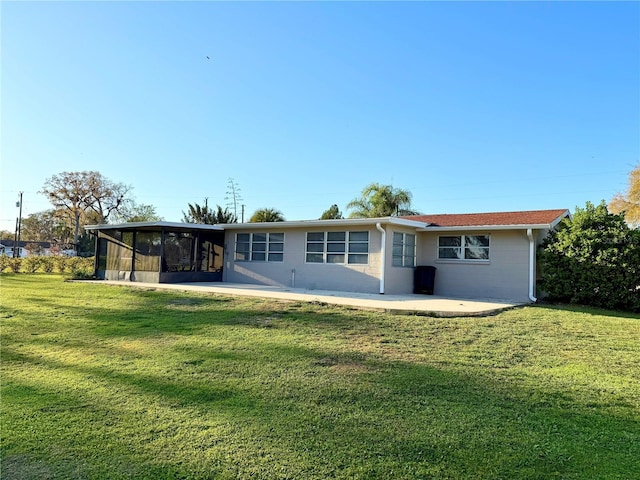 back of house with a yard, a patio, and a sunroom