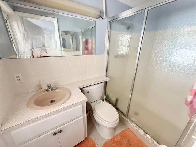 bathroom featuring vanity, tile patterned flooring, a shower stall, and toilet