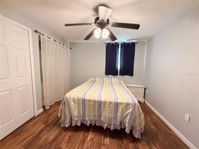 bedroom featuring a ceiling fan, baseboards, and wood finished floors
