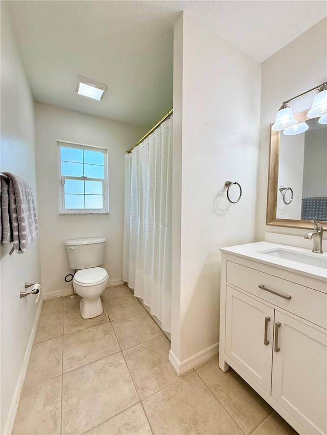 full bath with baseboards, vanity, toilet, and tile patterned floors