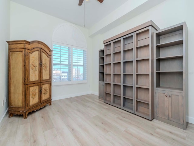 interior space featuring ceiling fan, light wood finished floors, and baseboards