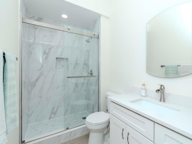 full bath featuring vanity, a marble finish shower, toilet, and recessed lighting