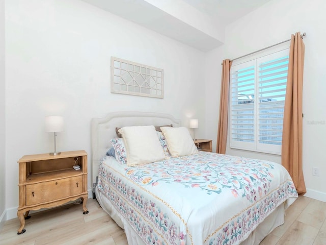 bedroom featuring wood finished floors and baseboards