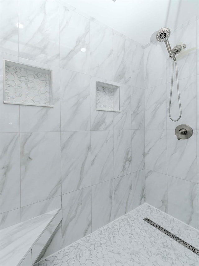 bathroom featuring a tile shower