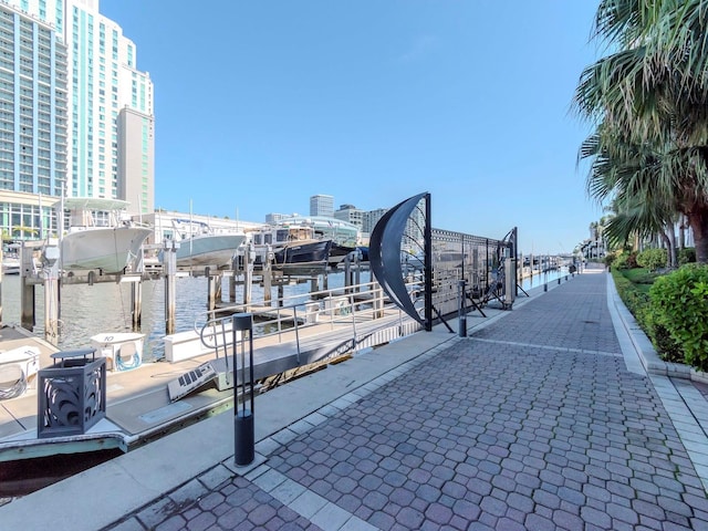 view of community featuring a dock, a water view, and boat lift