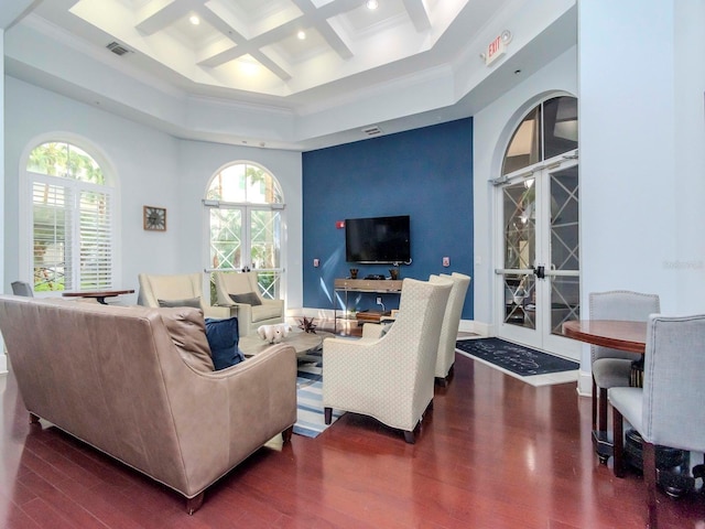 living area with plenty of natural light, visible vents, wood finished floors, and french doors