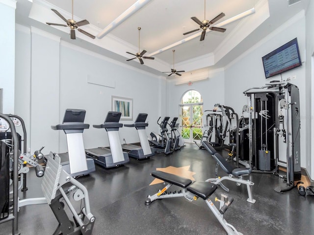 gym with ornamental molding, a raised ceiling, and visible vents