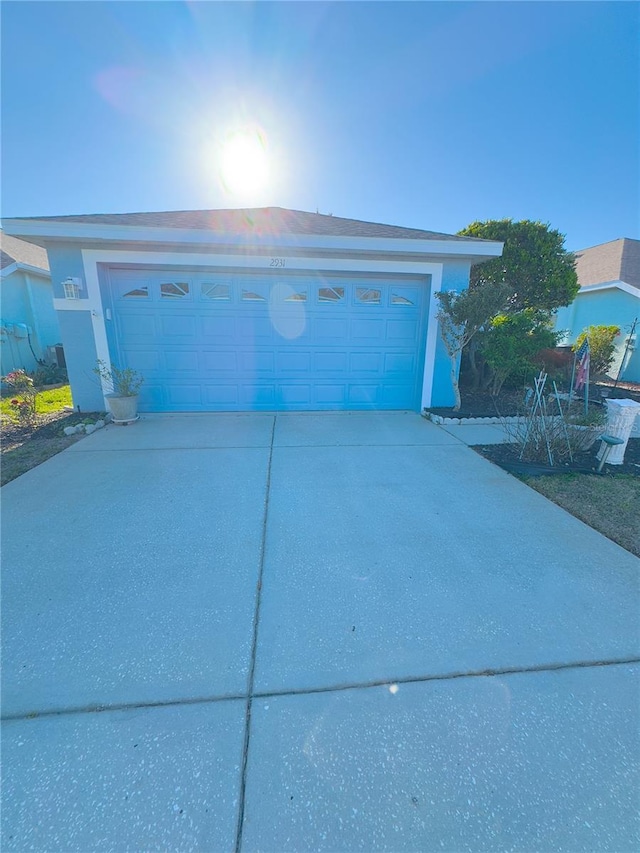 garage with concrete driveway