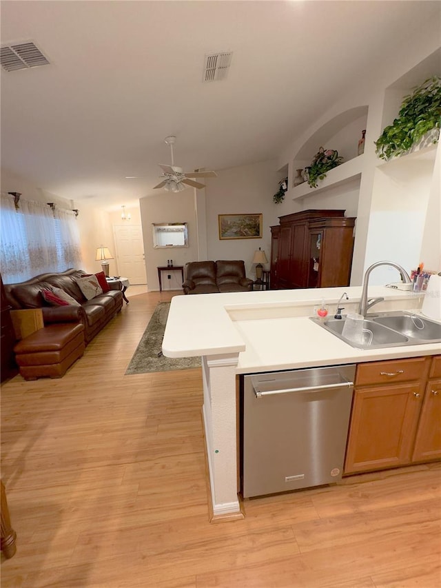 kitchen featuring dishwasher, open floor plan, a sink, and visible vents