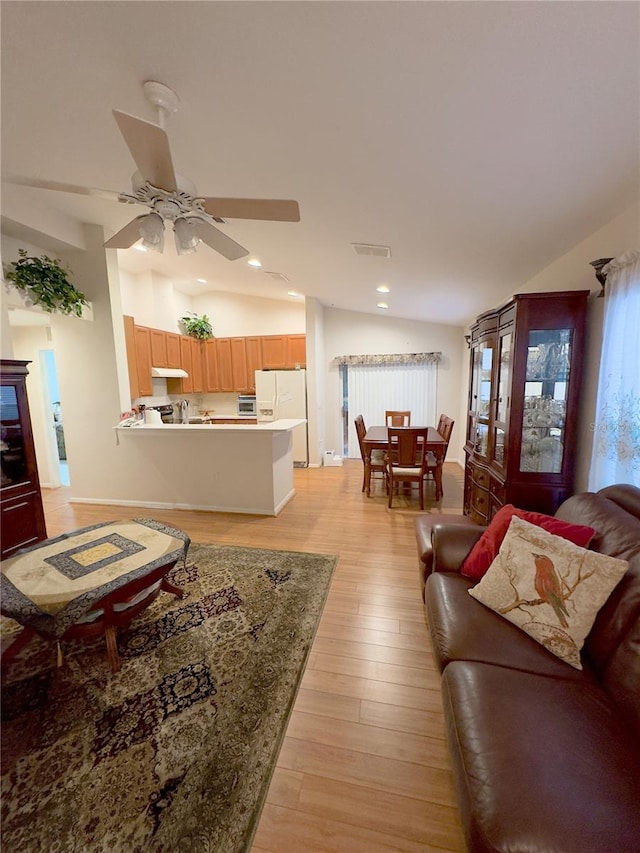 living room with lofted ceiling, recessed lighting, visible vents, a ceiling fan, and light wood finished floors