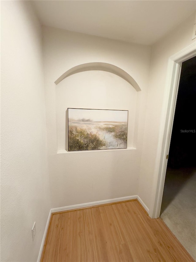 interior space featuring light wood finished floors and baseboards