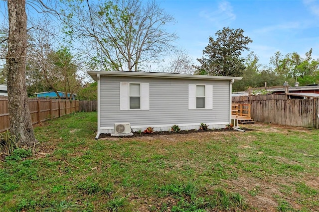 exterior space with ac unit and a fenced backyard