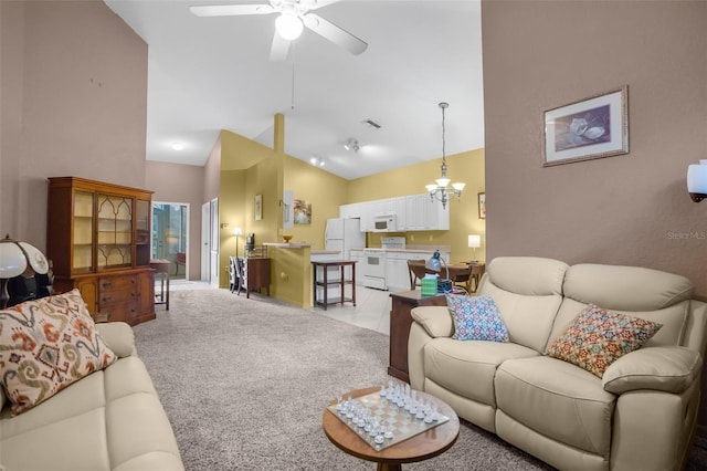 living area featuring light carpet, high vaulted ceiling, and ceiling fan with notable chandelier