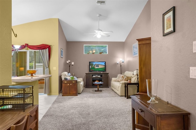 living room featuring lofted ceiling, plenty of natural light, visible vents, and light colored carpet