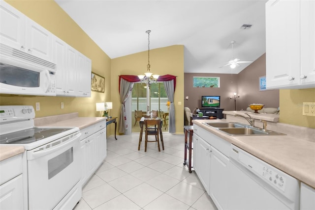 kitchen featuring light countertops, white appliances, a sink, and visible vents