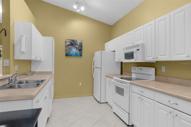 kitchen featuring white appliances, a sink, and white cabinetry