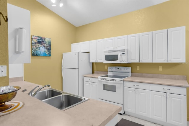 kitchen with light countertops, white appliances, a sink, and white cabinets