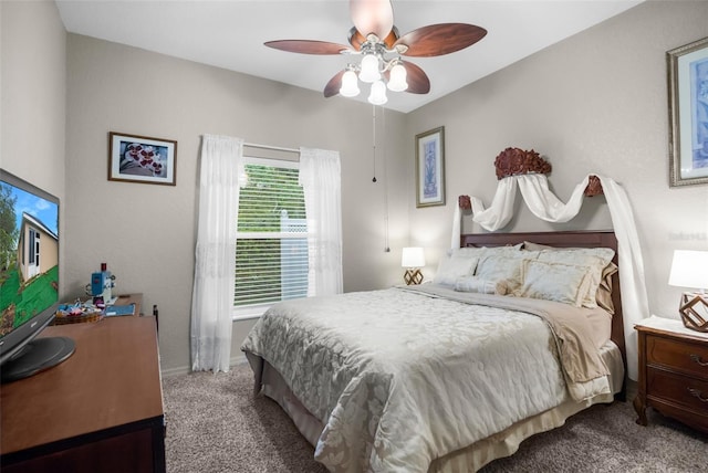 carpeted bedroom with a ceiling fan and baseboards