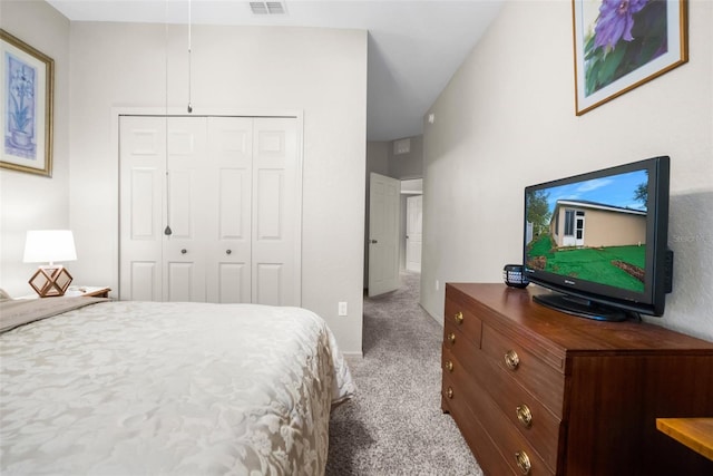 carpeted bedroom featuring a closet and visible vents