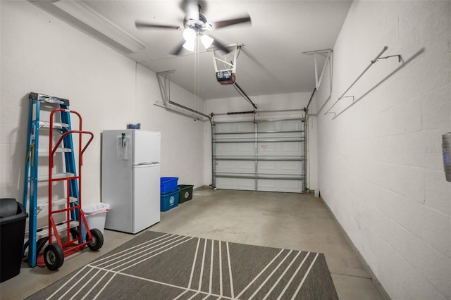 garage featuring a garage door opener and freestanding refrigerator