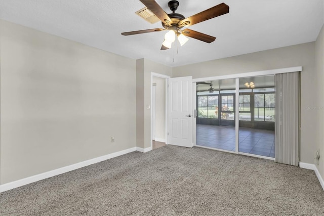 carpeted empty room with ceiling fan and baseboards