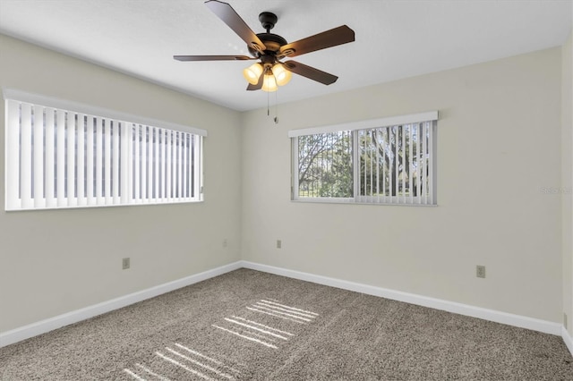 spare room with carpet flooring, ceiling fan, and baseboards