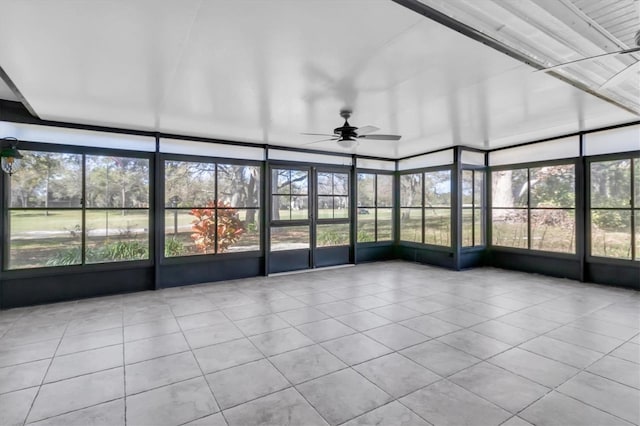 unfurnished sunroom with a ceiling fan