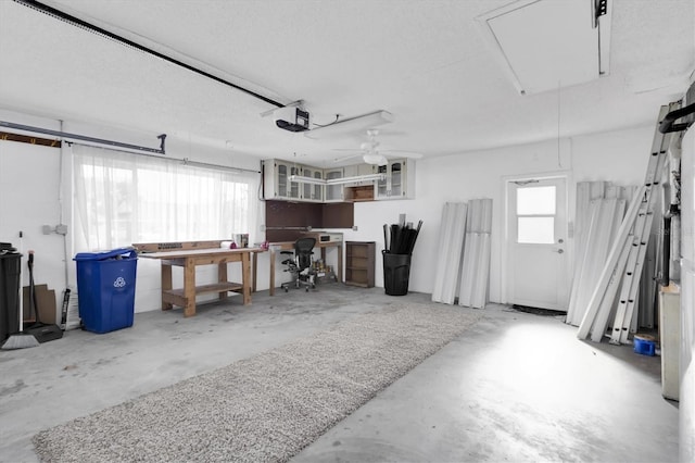 garage with a ceiling fan and a garage door opener