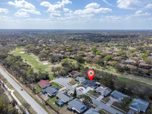 drone / aerial view featuring view of golf course and a residential view