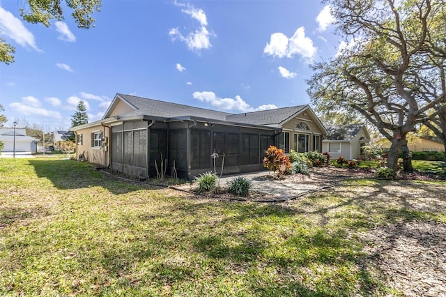 exterior space with a sunroom and a lawn