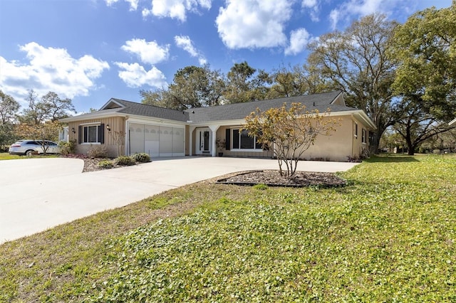 ranch-style house featuring a garage, concrete driveway, a front lawn, and board and batten siding