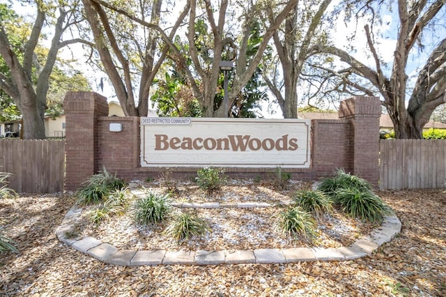 community sign featuring fence