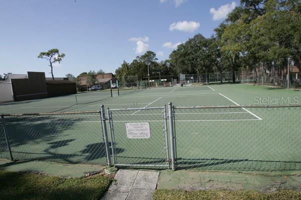 view of sport court featuring a gate and fence