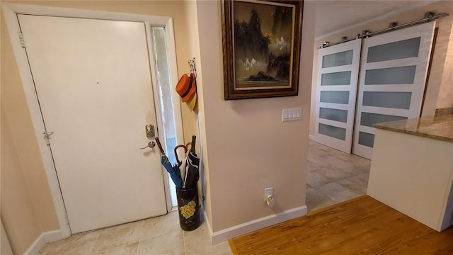 foyer featuring baseboards