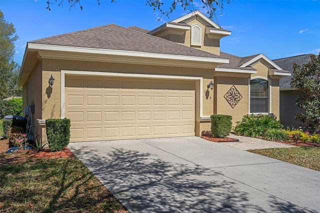 single story home with a shingled roof, driveway, an attached garage, and stucco siding