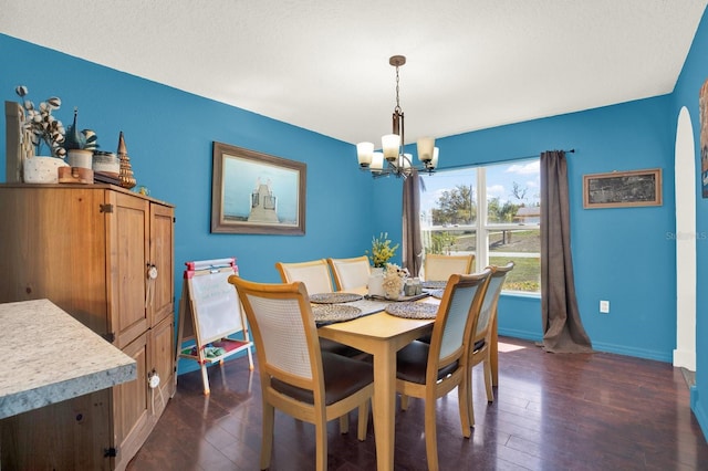 dining area with baseboards, a chandelier, and dark wood finished floors