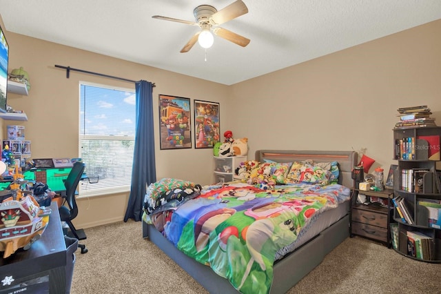 carpeted bedroom with a ceiling fan and baseboards