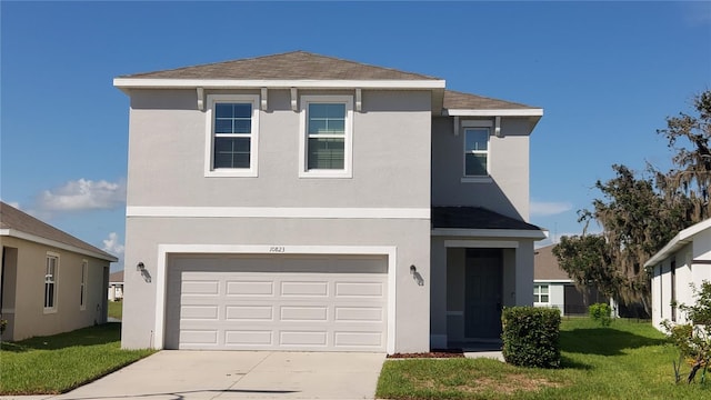 traditional-style home with roof with shingles, stucco siding, an attached garage, a front yard, and driveway