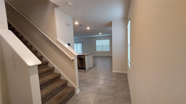 stairs with recessed lighting, visible vents, baseboards, and tile patterned floors